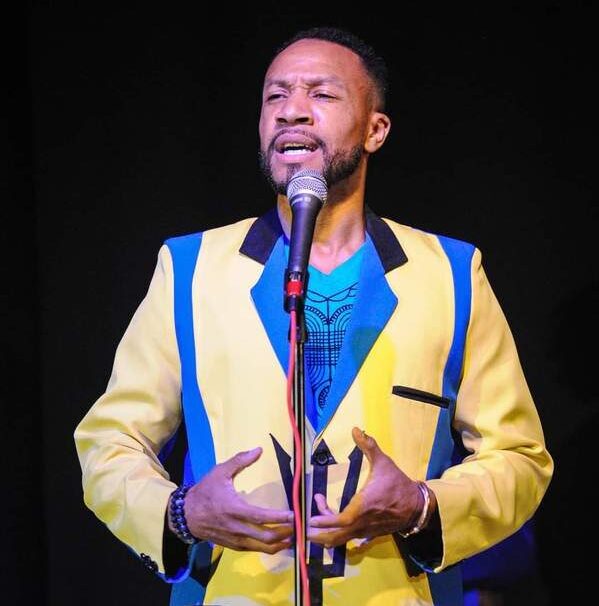 Negus Adeyemi in jacket with Barbadian colors